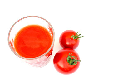 A glass tomato juice and tomato beside