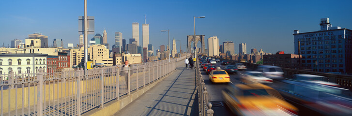 Panoramic view of speeding taxis driving over Brooklyn Bridge to Manhattan, New York City, NY
