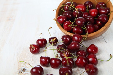 Naklejka na ściany i meble Ripe cherry in a wooden bowl