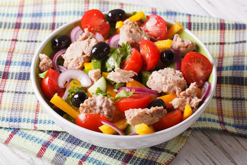 Fresh salad with tuna fish and vegetables in a bowl. horizontal
