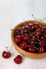 Ripe cherry in a wooden bowl