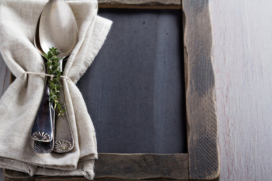 Tablespoons with a napkin and thyme