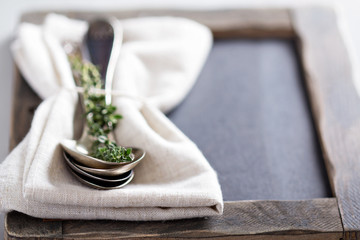 Tablespoons with a napkin and thyme