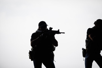Silhouette of terrorist with assault rifle