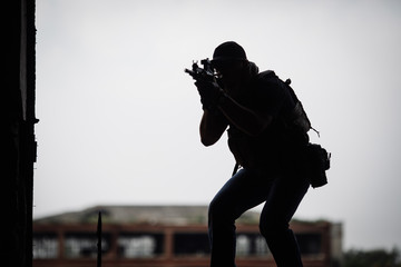 Silhouette of terrorist with assault rifle