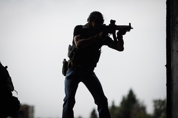 Silhouette of terrorist with assault rifle