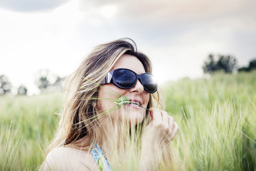 portrait of elegant lady with white hat in a wheat field