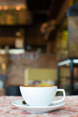 Cup of art latte or cappuccino coffee with retro filter effect a
