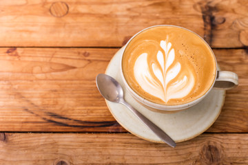 Hot art Latte Coffee in a cup on wooden table.