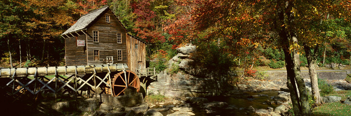 Panoramic of Glade Creek Grist Mil and autumn reflections and waterfall in Babcock State Park, WV