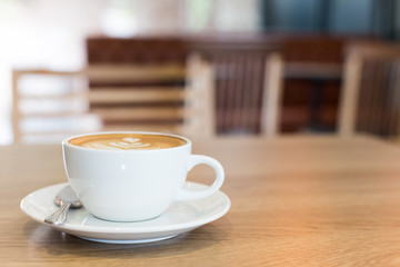 Hot art Latte Coffee in a cup on wooden table