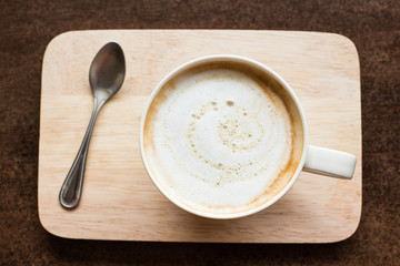 hot latte art coffee  on wooden table, vintage and retro style.