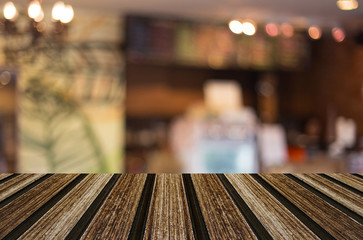 Selected focus empty brown wooden table and Coffee shop blur bac