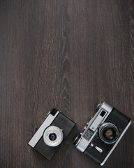 Two vintage camera on wooden background