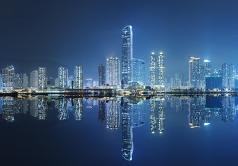 Modern buildings and harbor in Hong Kong at night