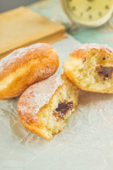 Naklejka na ściany i meble Sweet sugary donuts on rustic table