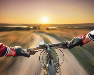 Fast ride on bike in mountain valley. Sport and active life concept