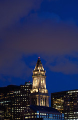 Obraz premium Sunset reflects in windows of Boston skyline and Commerce House Tower shot at dusk, Boston, MA.