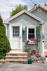 Cute home with flowers on front porch, summer, Maine.