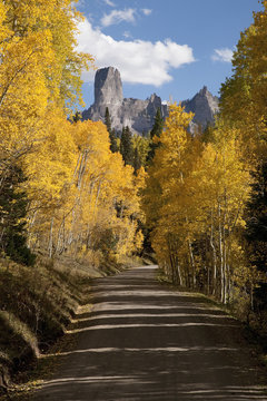 Dirt road leads to Chimney Peak and Courthouse Mountain in the Uncompahgre National Forest, Colorado.