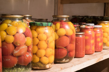 Pickled Tomatoes in Jars in a Raw in the Cellar 