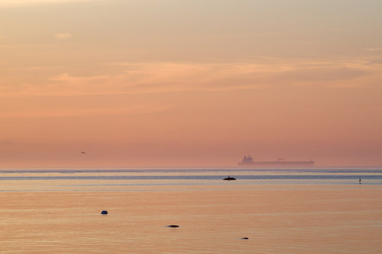 Cargo ship in blue water haze after sunset
