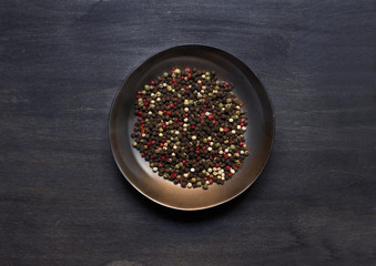 Plate with condiment on dark background