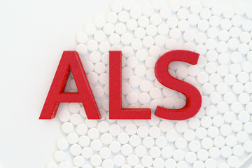 ALS - Amyotrophe lateralsklerose font and white pills - 3d Rendered illustration