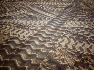 Wheel tracks on the soil.