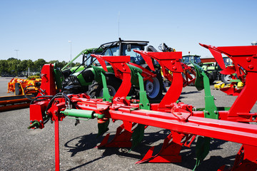 giant plows with tractors in background, latest models
