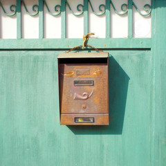 Old Mailbox on a green gate