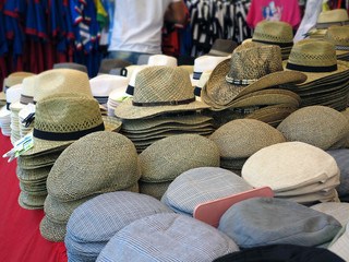 Hats sale on the market stall with people in the Background