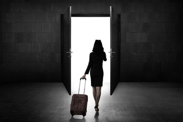 Back view of business woman standing toward door