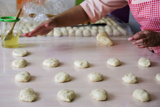 woman hands knead dough on a table