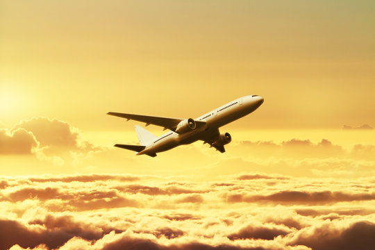 Fototapeta Airplane in the sky at sunset