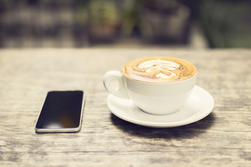 Cappuccino and a cell phone outdoor