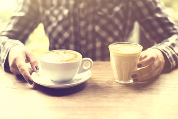 Hipster girl with cup of coffee and cappuccino