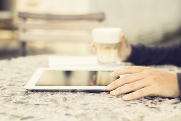 Digital tablet and coffee outdoor