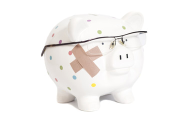 Bandaged piggy bank with eyeglasses