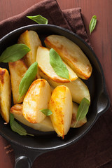 baked potato wedges in black frying pan