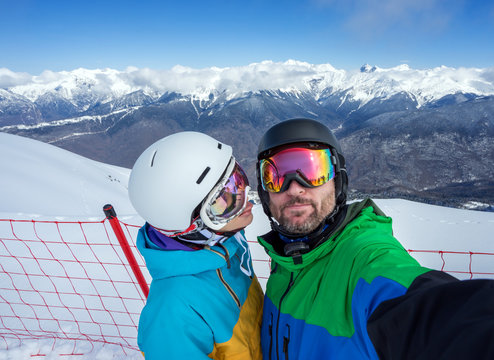 Couple snowboarders doing selfie on camera