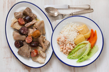 typical portuguese dish on plate on white wooden background