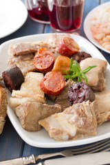 portuguese dish with red wine on blue wooden background