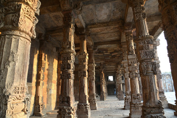 Carving Sandstone Columns in the courtyard of Quwwat-Ul-Islam mosque inside Qutub Minar complex