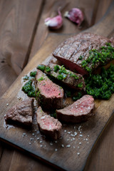 Medium rare grilled barbecue beefsteak with chimichurri sauce