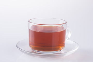 Tea in glass cup or glass cup of black tea on a background.