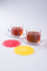 Tea in glass cup or glass cup of black tea on a background.