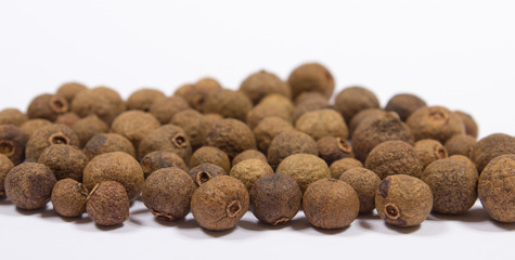 Grains of allspice isolated on white