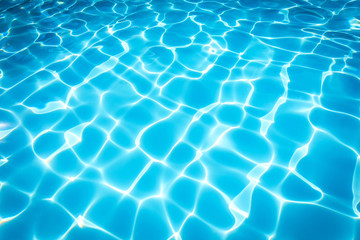 Pattern of blue water surface in swimming pool 