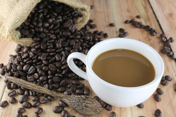 White coffee cup and roasted coffee beans.